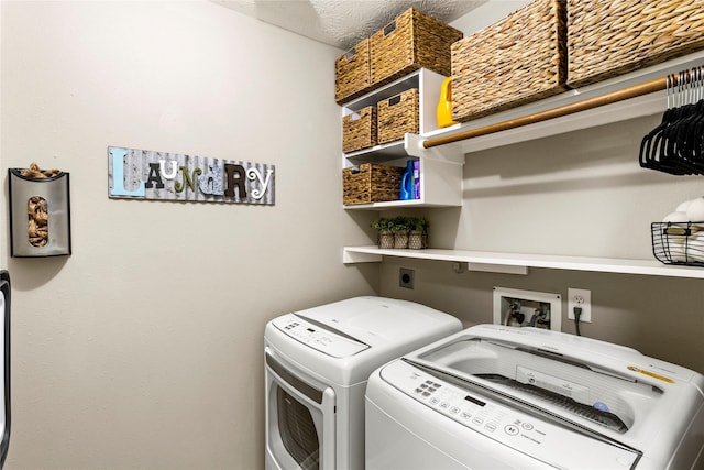 clothes washing area featuring washer and clothes dryer