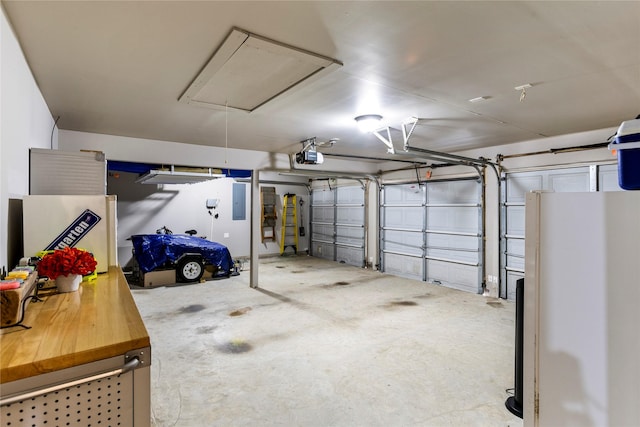 garage featuring a garage door opener and refrigerator