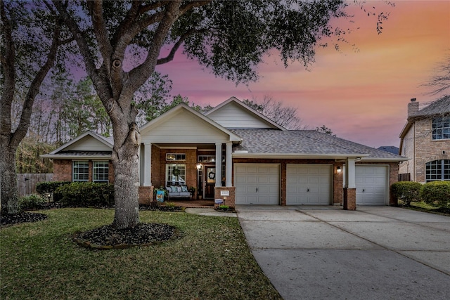 view of front facade featuring a garage and a yard