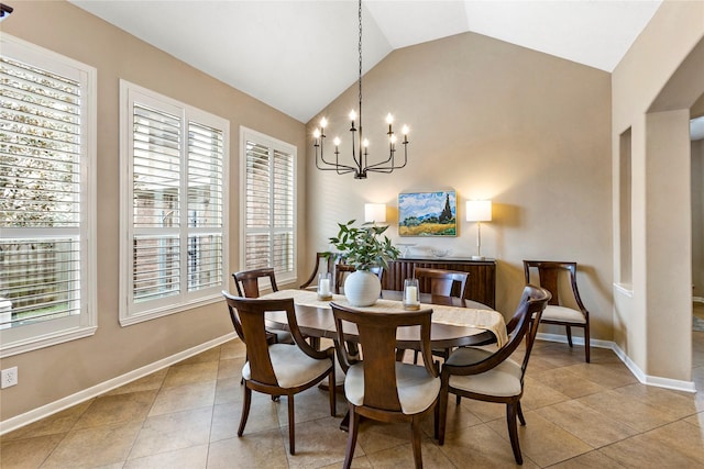 dining area featuring light tile patterned flooring, lofted ceiling, and a chandelier