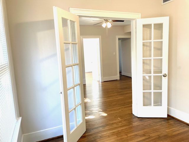 empty room featuring dark hardwood / wood-style floors, french doors, and ceiling fan