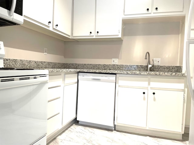 kitchen with white appliances, stone countertops, sink, and white cabinets