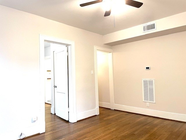 unfurnished room with dark hardwood / wood-style floors and ceiling fan