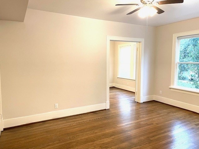 spare room featuring ceiling fan and dark hardwood / wood-style flooring