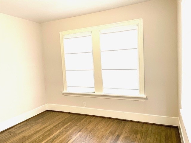 unfurnished room with hardwood / wood-style flooring