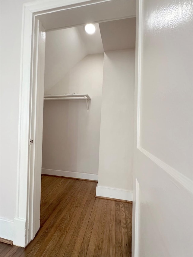 spacious closet featuring vaulted ceiling and wood finished floors