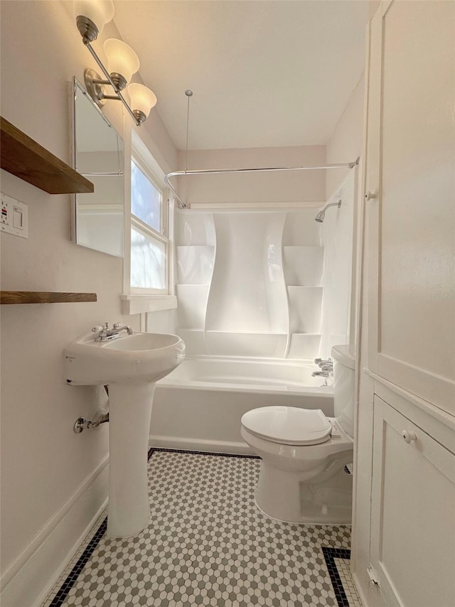 full bathroom with  shower combination, baseboards, and toilet