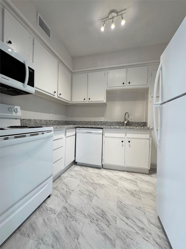 kitchen with white appliances, visible vents, marble finish floor, and white cabinetry