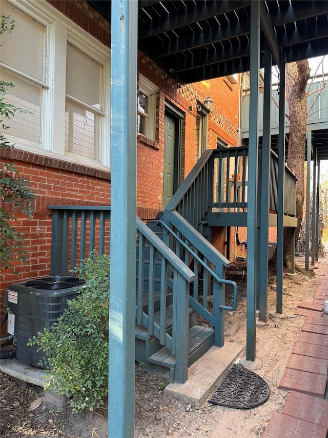 view of play area featuring stairway and central AC unit