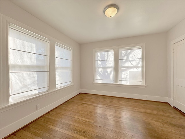 unfurnished room featuring light wood-style flooring and baseboards