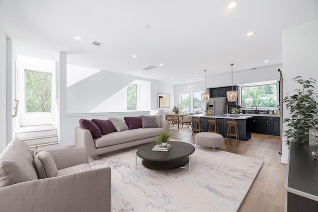 living room featuring sink and light wood-type flooring