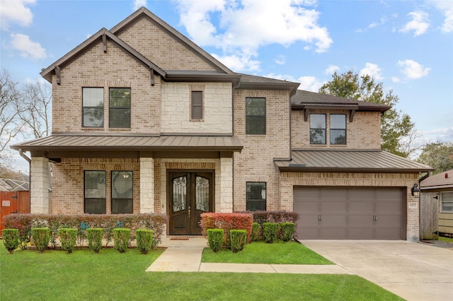 view of front of property featuring a garage and a front lawn