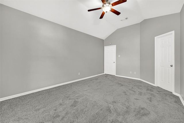 carpeted spare room featuring ceiling fan and vaulted ceiling