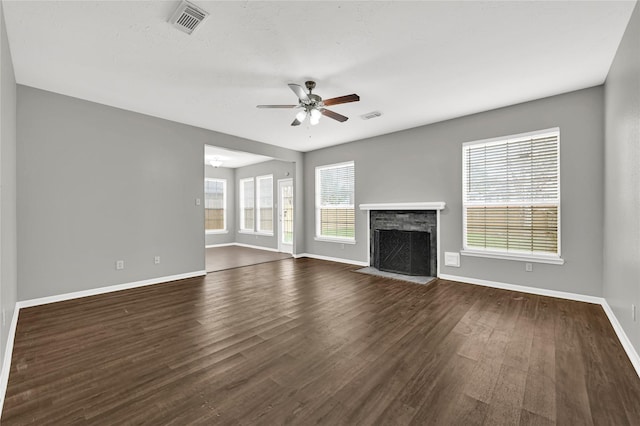 unfurnished living room with dark hardwood / wood-style floors and ceiling fan