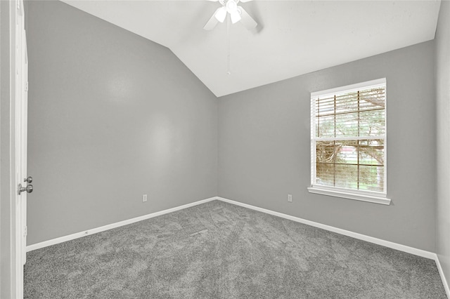 carpeted spare room featuring ceiling fan and lofted ceiling