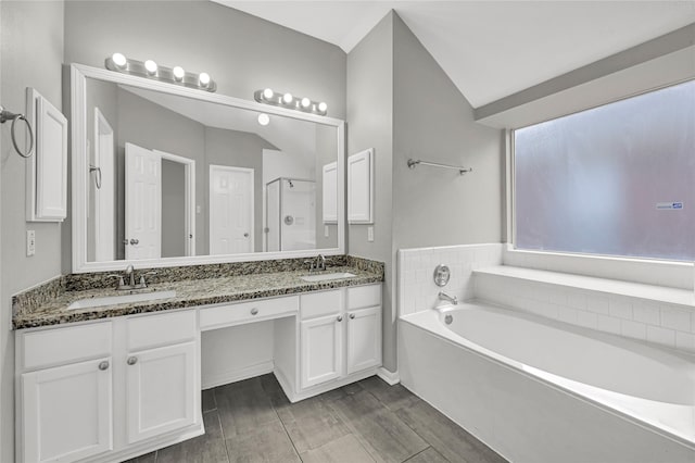 bathroom featuring vanity and shower with separate bathtub