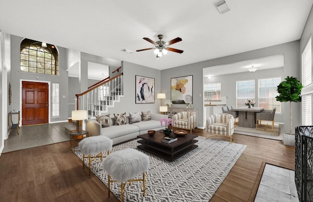 living room with hardwood / wood-style floors and ceiling fan