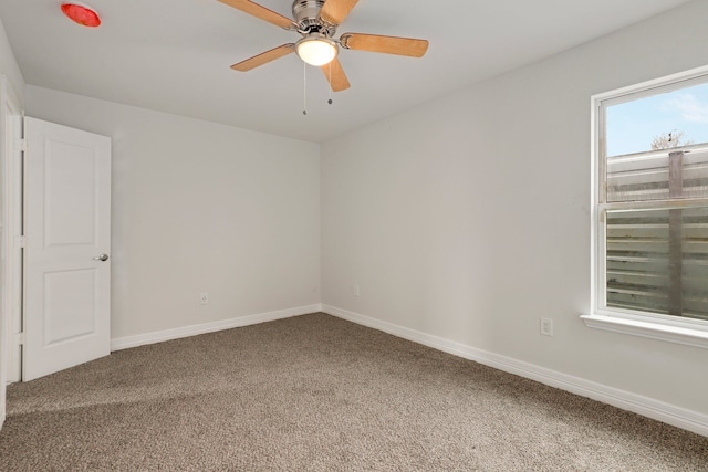 empty room featuring ceiling fan and carpet floors