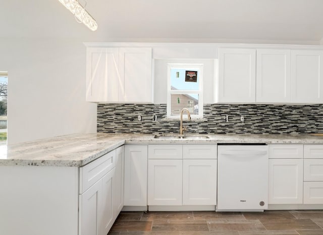 kitchen with sink, white cabinetry, white dishwasher, tasteful backsplash, and light stone counters