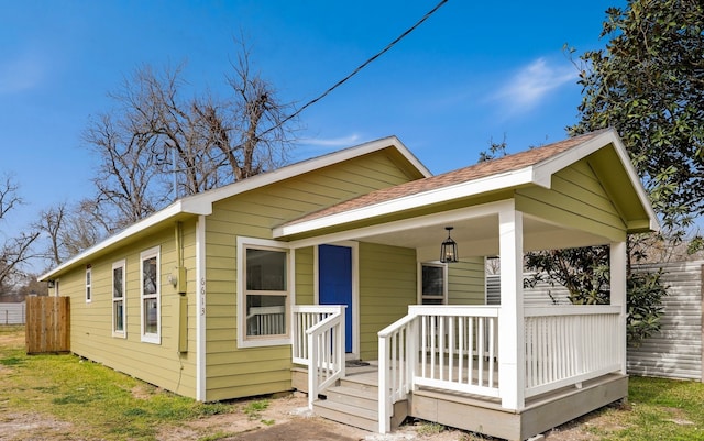 rear view of property with covered porch