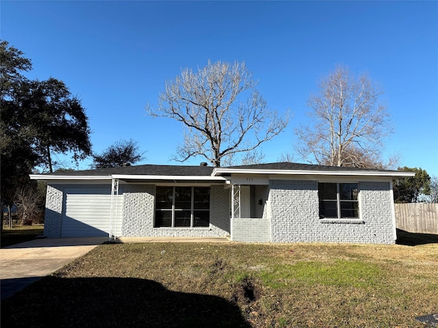 ranch-style home with a garage and a front yard