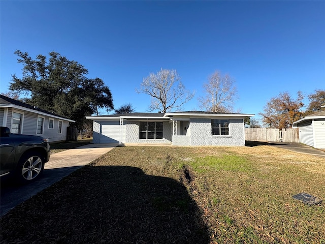 view of front of property featuring a garage and a front lawn