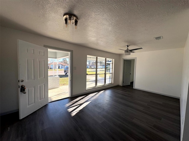 interior space with ceiling fan, a textured ceiling, and dark hardwood / wood-style flooring