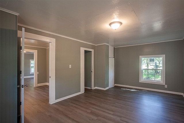 unfurnished bedroom featuring crown molding, dark hardwood / wood-style floors, and a closet