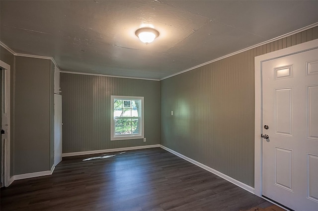 unfurnished room with baseboards, dark wood-style flooring, and crown molding