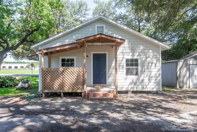 bungalow-style house featuring an outbuilding