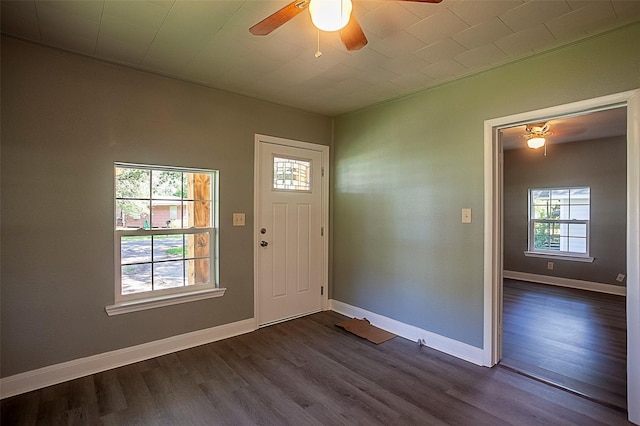 foyer entrance with ceiling fan, dark wood-type flooring, and a healthy amount of sunlight