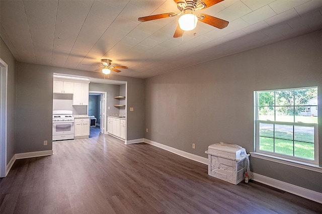 unfurnished living room featuring dark hardwood / wood-style floors and ceiling fan