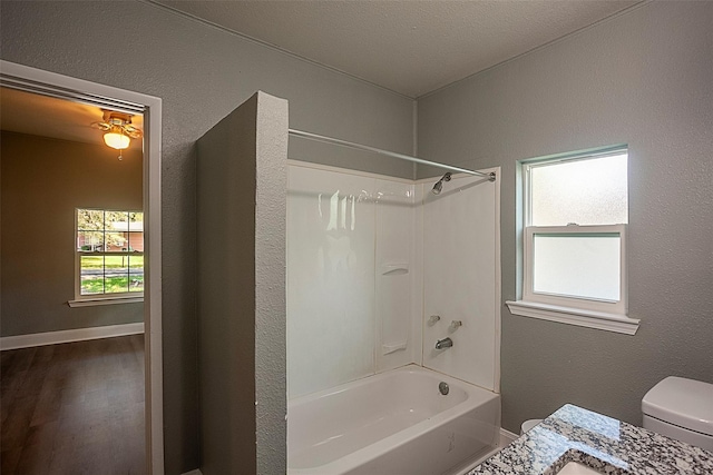 full bathroom featuring vanity, hardwood / wood-style floors, tub / shower combination, and toilet