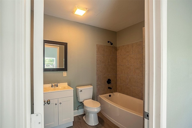 bathroom featuring baseboards, toilet, wood finished floors, vanity, and washtub / shower combination