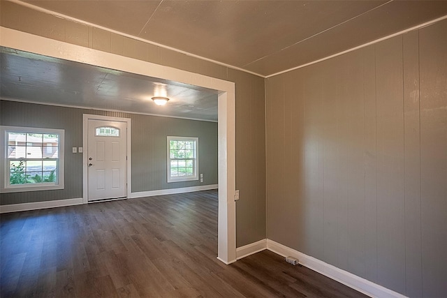 entryway featuring ornamental molding and dark wood-type flooring