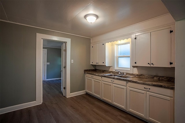 kitchen featuring sink, dark wood-type flooring, and white cabinets