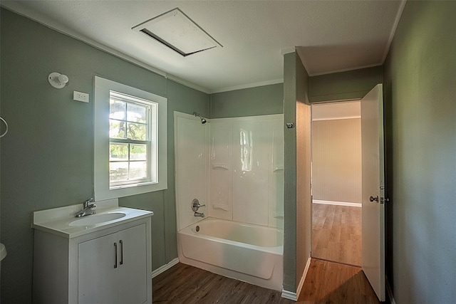 full bath with shower / bathing tub combination, wood finished floors, vanity, and crown molding