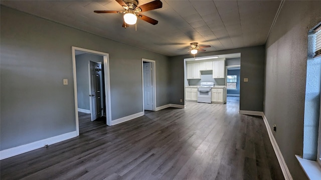 unfurnished living room with wood finished floors, a ceiling fan, and baseboards