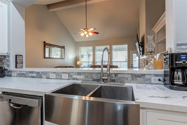 kitchen featuring sink, lofted ceiling with beams, light stone countertops, white cabinets, and stainless steel dishwasher