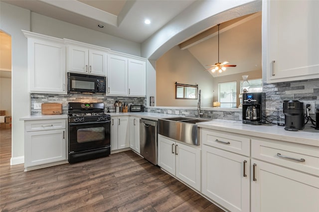 kitchen with pendant lighting, sink, white cabinetry, lofted ceiling with beams, and black appliances