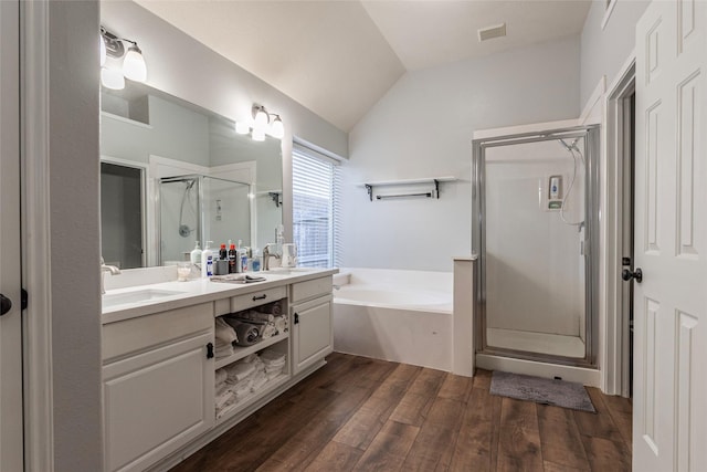 bathroom with lofted ceiling, wood-type flooring, separate shower and tub, and vanity