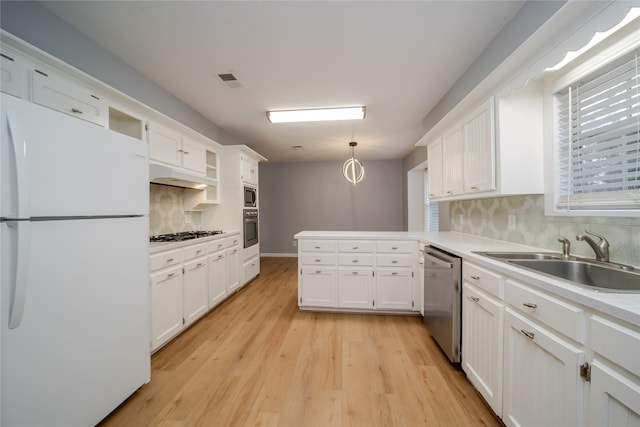 kitchen featuring decorative light fixtures, sink, white cabinets, stainless steel appliances, and light wood-type flooring