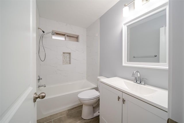 full bathroom featuring vanity, tiled shower / bath, and toilet