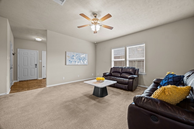 carpeted living room with a textured ceiling and ceiling fan