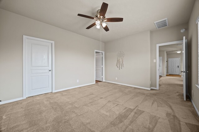 unfurnished bedroom featuring ceiling fan and light carpet