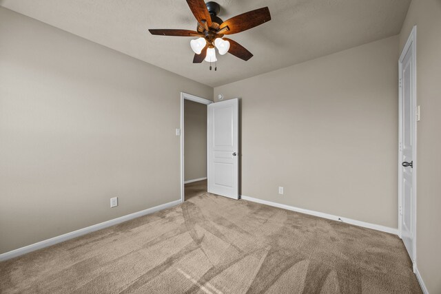 unfurnished bedroom featuring ceiling fan and light colored carpet