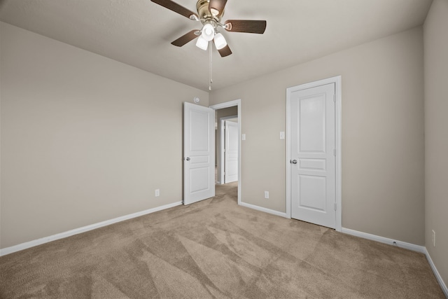 unfurnished bedroom with light colored carpet and ceiling fan