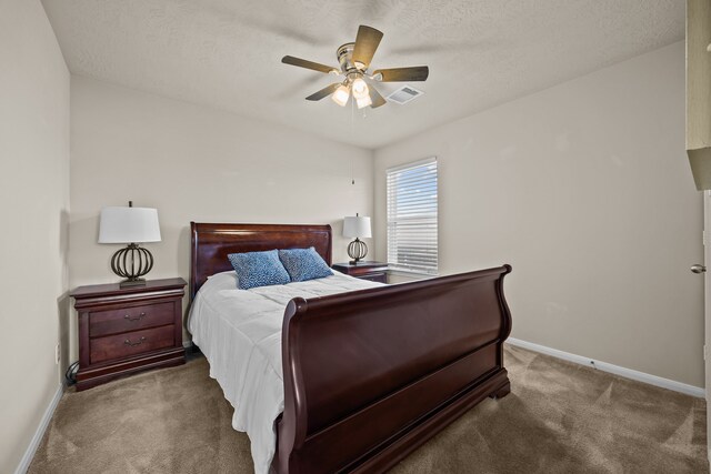 bedroom with ceiling fan, a textured ceiling, and carpet flooring