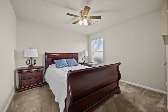 carpeted bedroom with visible vents, ceiling fan, a textured ceiling, and baseboards