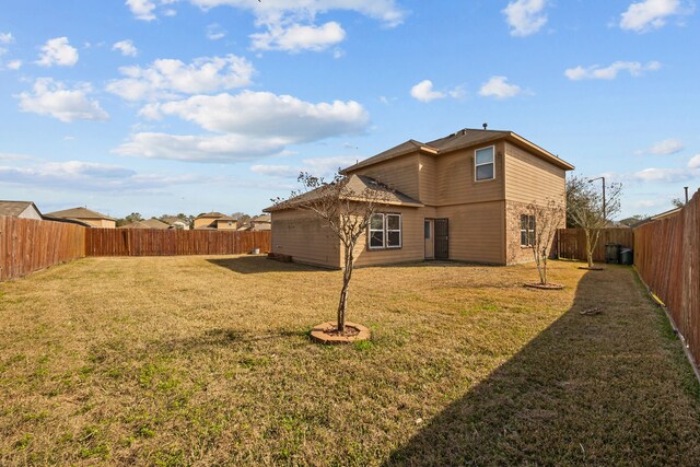 rear view of house with a yard and central air condition unit